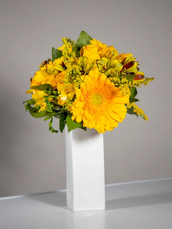 Bouquet giallo di rose e gerbere in vaso bianco